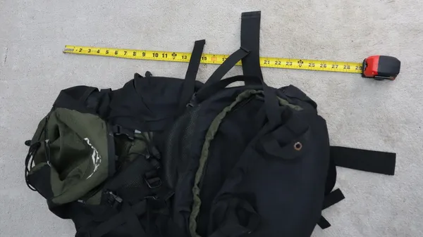Teton Scout lying on the floor with a tape measure across the top